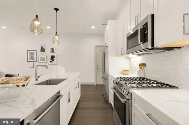 a kitchen that has a sink and a stove