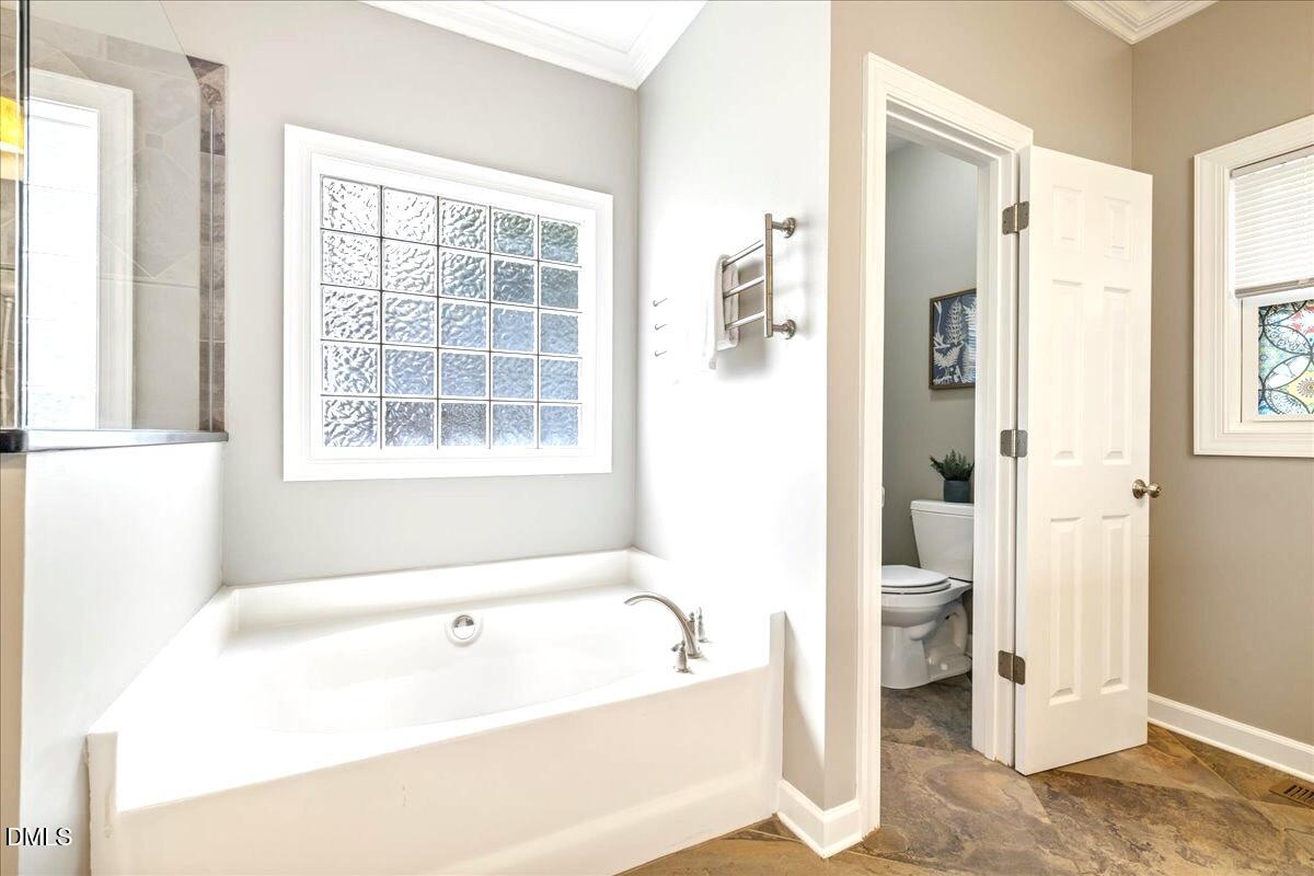 3205 Suncrest Village Lane Raleigh, NC 27616 - Photo 10 of 29 a bathroom with a bathtub and a shower