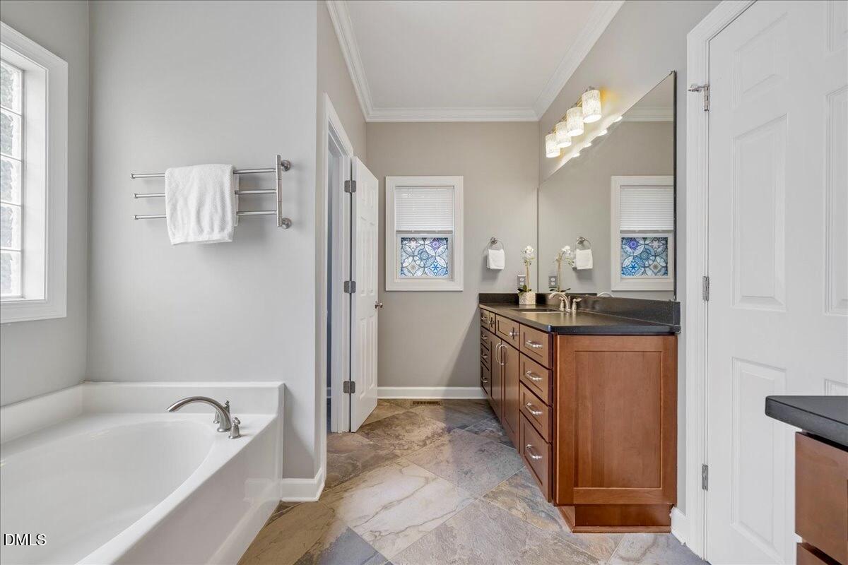 3205 Suncrest Village Lane Raleigh, NC 27616 - Photo 11 of 29 a bathroom with a tub sink and mirror