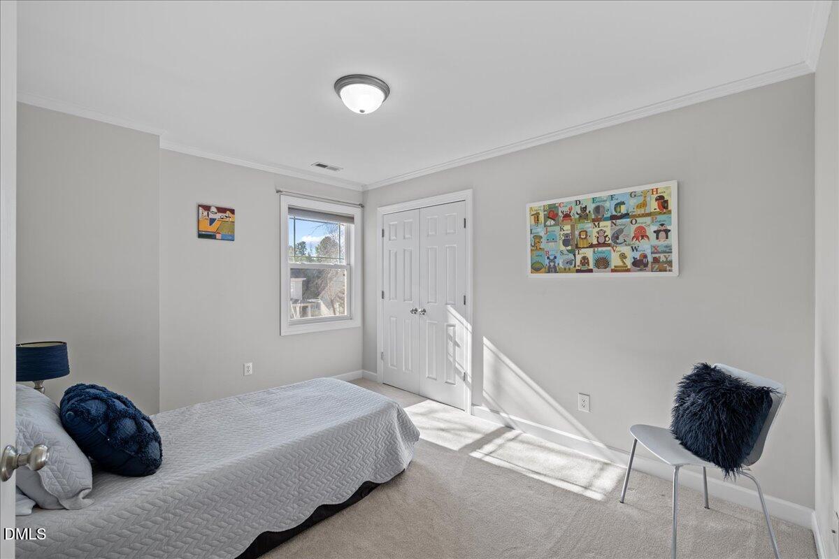 3205 Suncrest Village Lane Raleigh, NC 27616 - Photo 19 of 29 a bedroom with a bed and a window