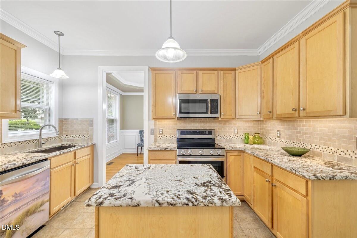3205 Suncrest Village Lane Raleigh, NC 27616 - Photo 21 of 29 a kitchen with a sink stove top oven and refrigerator