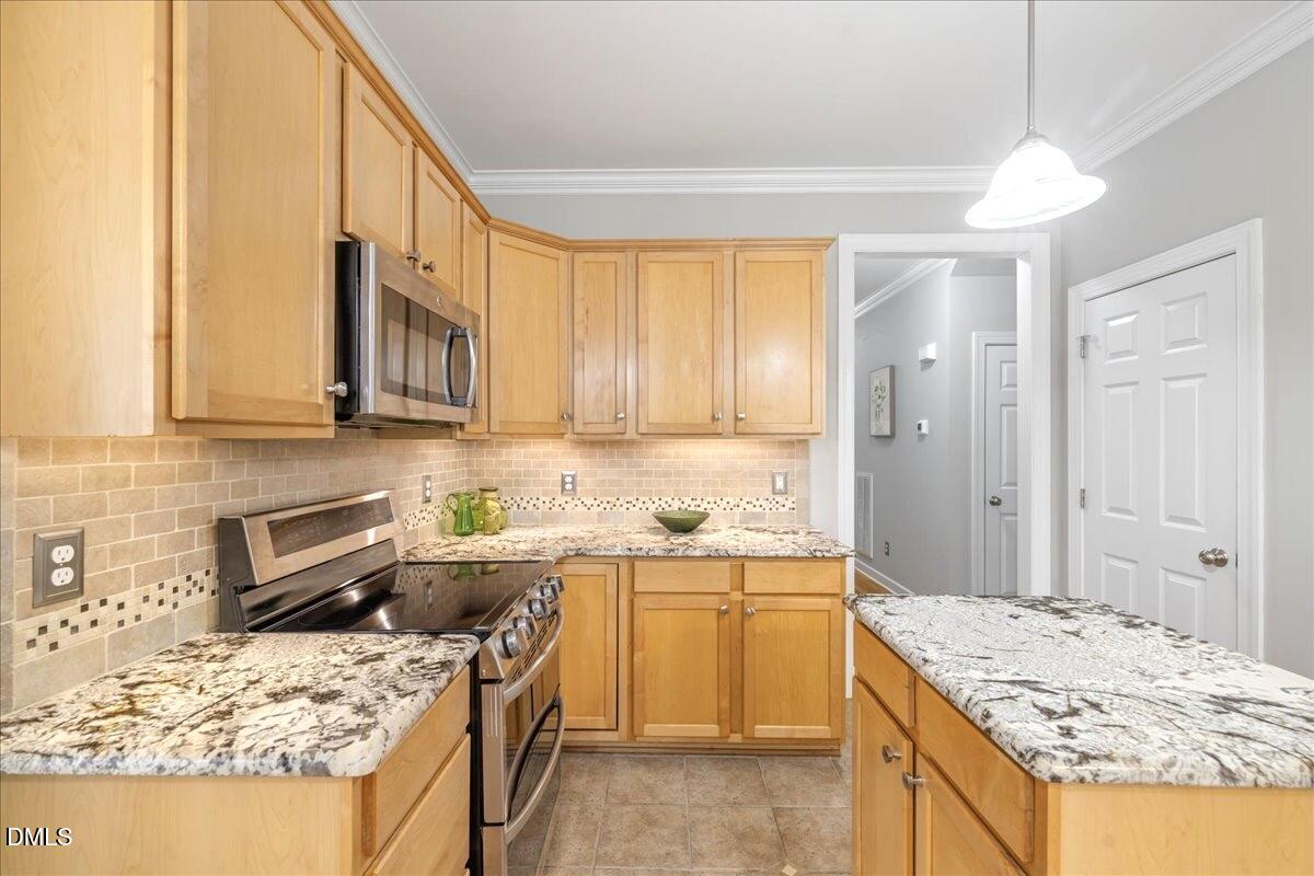 3205 Suncrest Village Lane Raleigh, NC 27616 - Photo 22 of 29 a kitchen with a sink stove and refrigerator