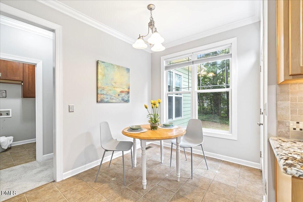 3205 Suncrest Village Lane Raleigh, NC 27616 - Photo 23 of 29 a dining room with furniture and window