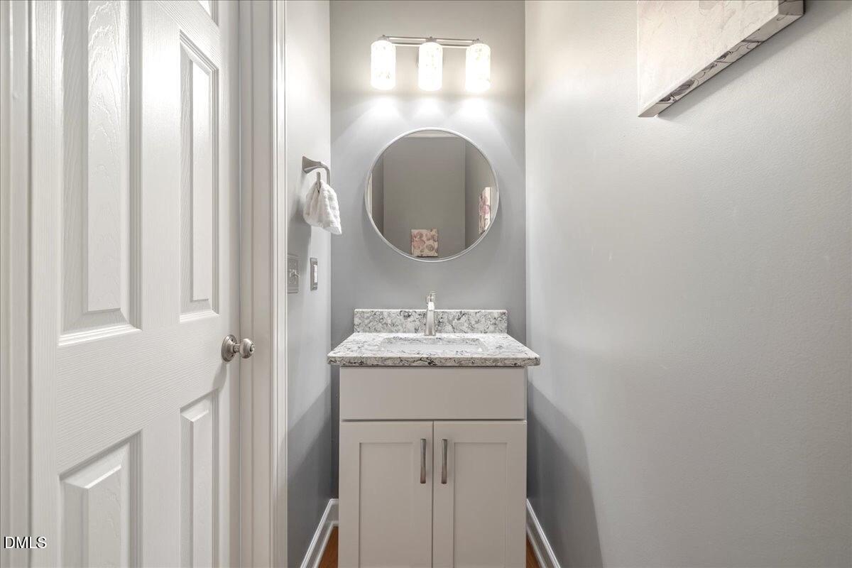 3205 Suncrest Village Lane Raleigh, NC 27616 - Photo 24 of 29 a bathroom with a mirror and a sink