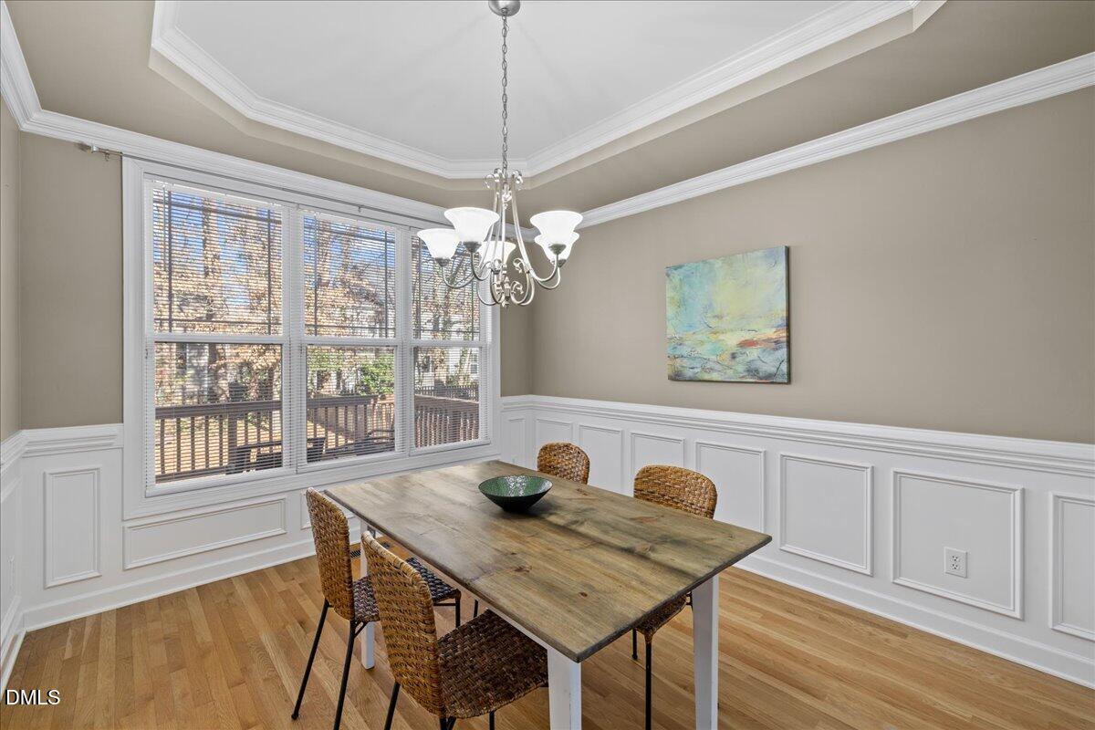 3205 Suncrest Village Lane Raleigh, NC 27616 - Photo 5 of 29 a view of a dining room with furniture wooden floor and chandelier