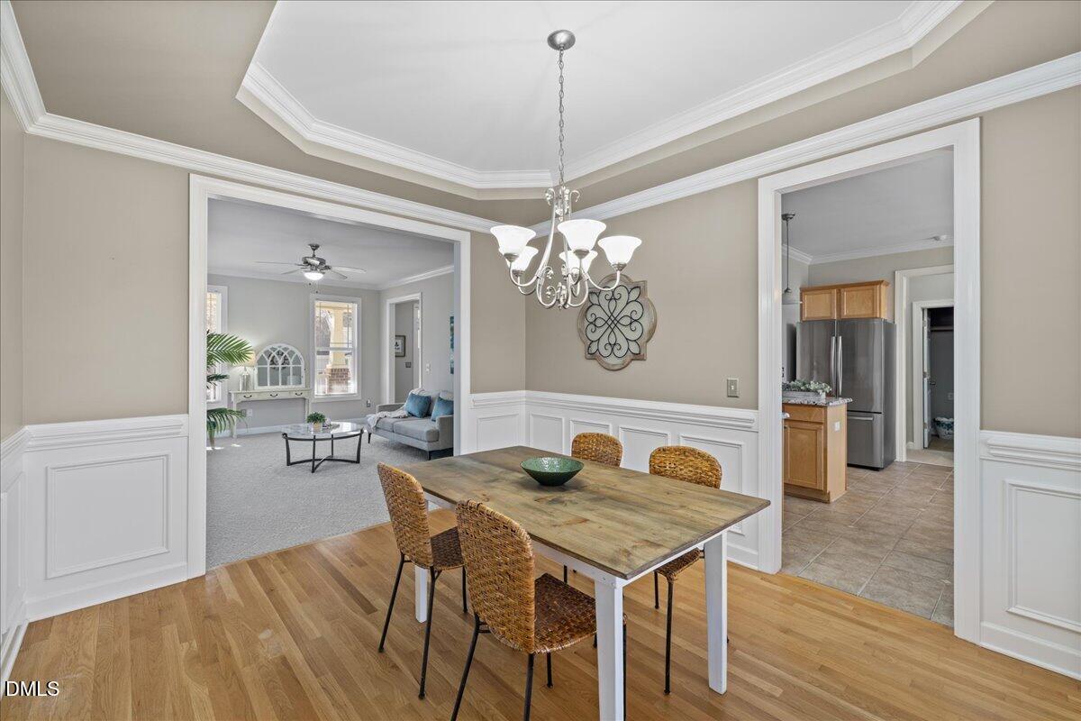 3205 Suncrest Village Lane Raleigh, NC 27616 - Photo 6 of 29 a view of a dining room with furniture and wooden floor