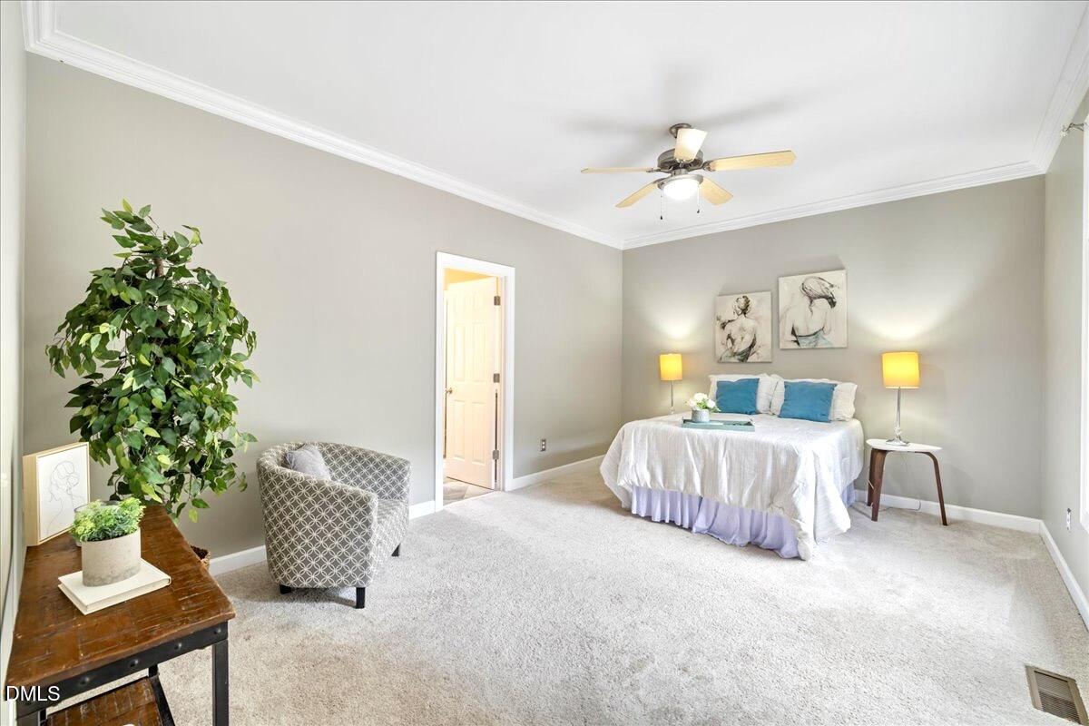 3205 Suncrest Village Lane Raleigh, NC 27616 - Photo 7 of 29 a bedroom with a bed and a couch