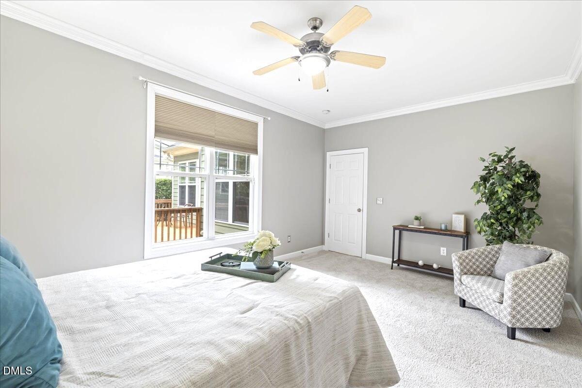 3205 Suncrest Village Lane Raleigh, NC 27616 - Photo 8 of 29 a bedroom with a bed and a chandelier