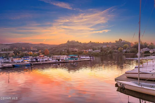 a view of a lake with a table and chairs