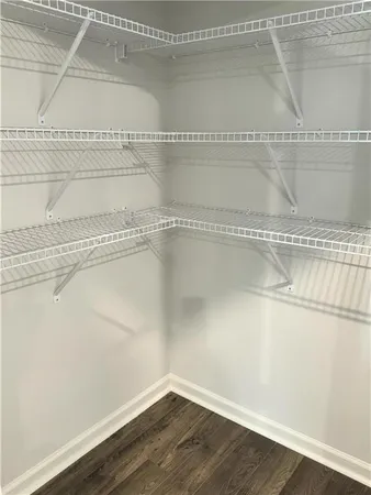 a view of a room with wooden floor