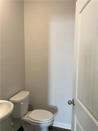 a white toilet sitting next to a shower