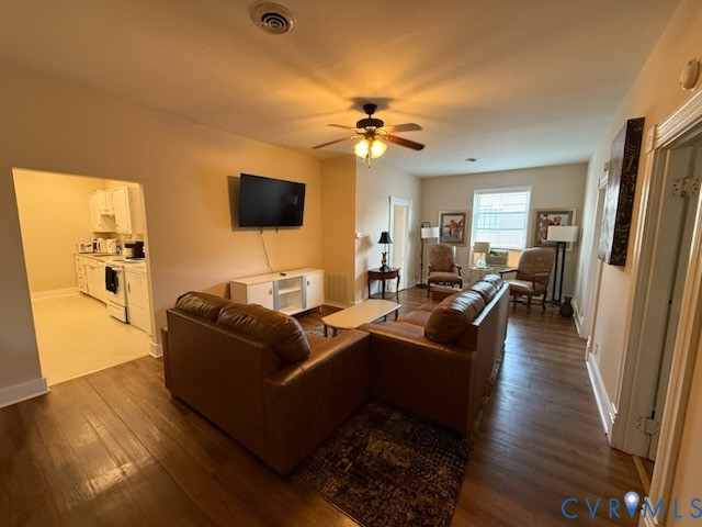 a living room with furniture a flat screen tv and a table