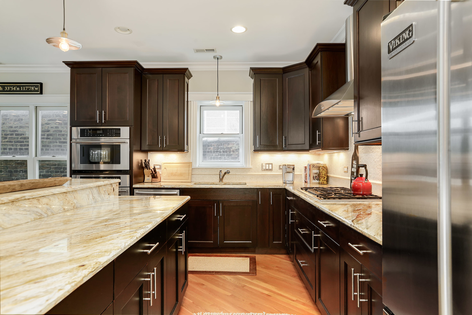 456 West Briar Place, Unit 4 Chicago, IL 60657 - Photo 11 of 30 a kitchen with stainless steel appliances granite countertop a sink stove and refrigerator