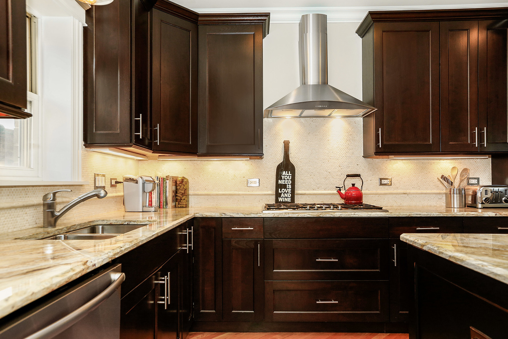 456 West Briar Place, Unit 4 Chicago, IL 60657 - Photo 12 of 30 a kitchen with granite countertop a sink stainless steel appliances and cabinets