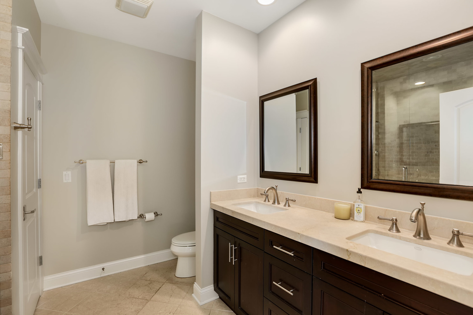 456 West Briar Place, Unit 4 Chicago, IL 60657 - Photo 16 of 30 a bathroom with a double vanity sink and a mirror