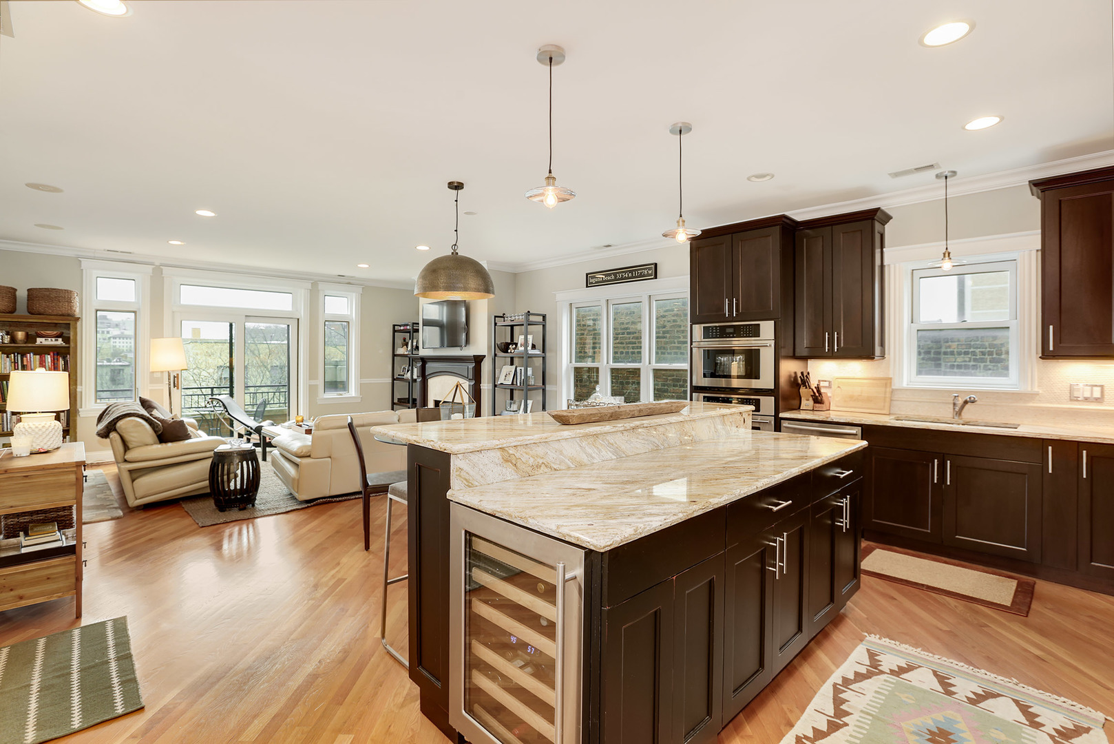 456 West Briar Place, Unit 4 Chicago, IL 60657 - Photo 8 of 30 a kitchen with kitchen island granite countertop a sink stove and wooden floor
