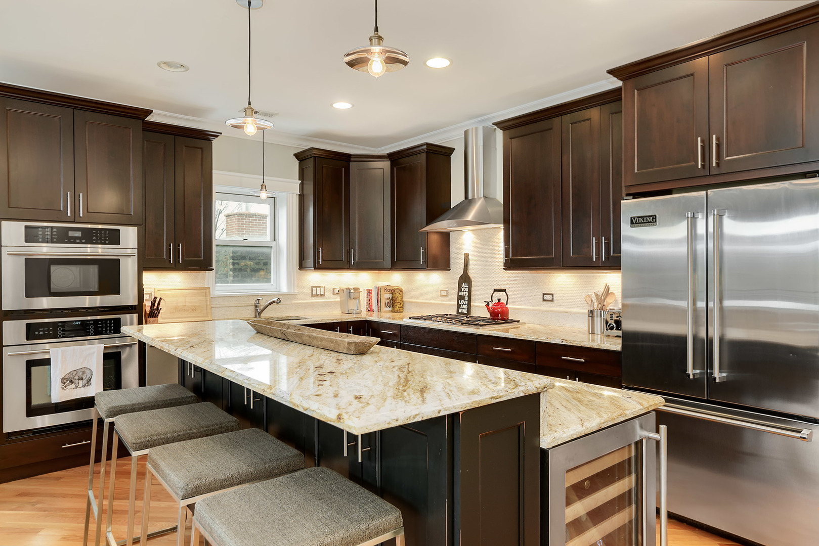 456 West Briar Place, Unit 4 Chicago, IL 60657 - Photo 10 of 30 a kitchen with a sink a counter top space stainless steel appliances and cabinets