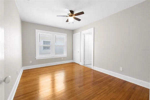 wooden floor in an empty room with a window