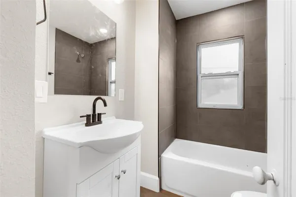 a bathroom with a sink a toilet and bathtub