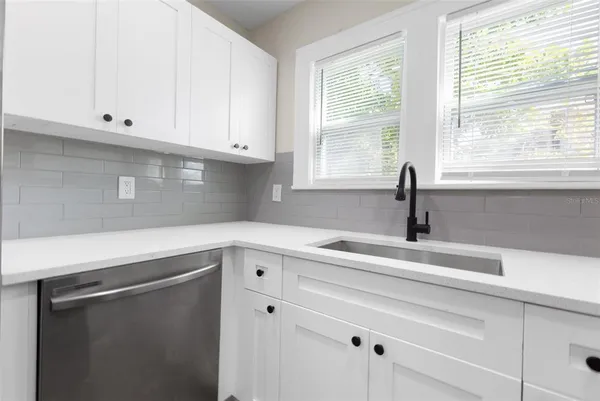 a kitchen with appliances cabinets and a window