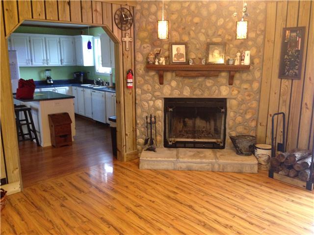 3832 Flewellyn Road Springfield, TN 37172 - Photo 2 of 19 a kitchen with granite countertop wooden floors and a fireplace