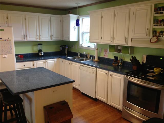 3832 Flewellyn Road Springfield, TN 37172 - Photo 4 of 19 a kitchen with stainless steel appliances granite countertop a stove a sink a microwave and cabinets
