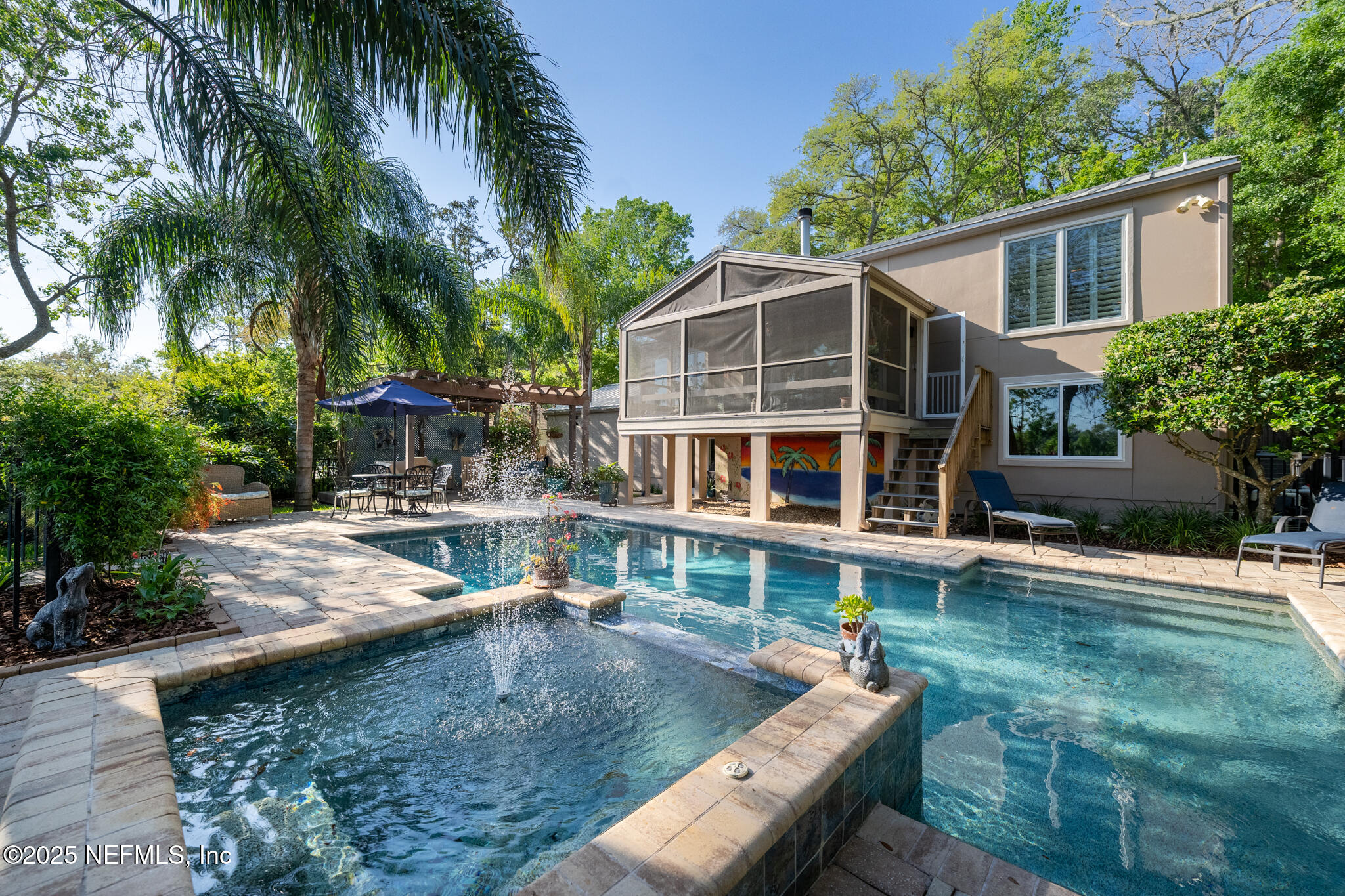 a view of a house with pool and sitting area
