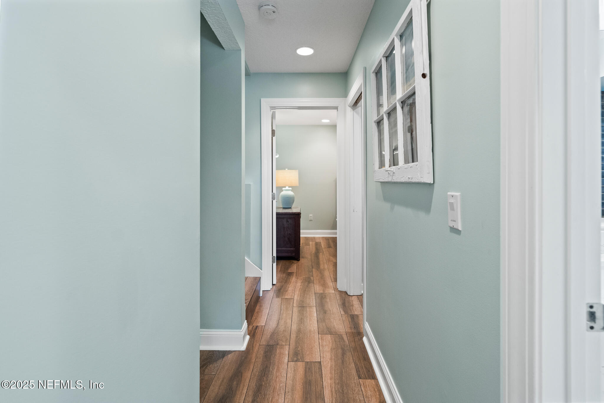 1836 Nightfall Drive Neptune Beach, FL 32266 - Photo 25 of 56 a view of a hallway with wooden floor and a bathroom