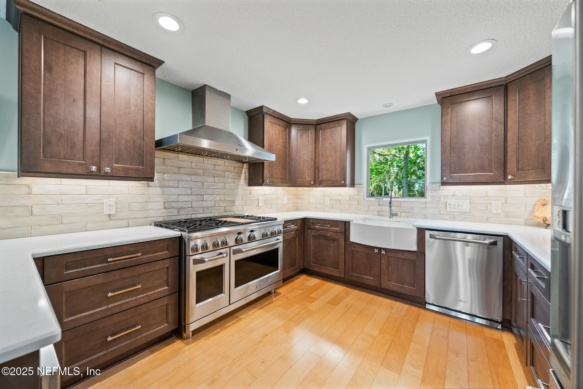 1836 Nightfall Drive Neptune Beach, FL 32266 - Photo 7 of 56 a kitchen with stainless steel appliances granite countertop wooden cabinets stove top oven and sink