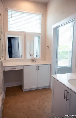 a bathroom with a sink vanity and mirror