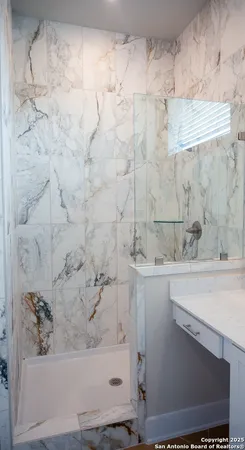 a bathroom with a bathtub and shower