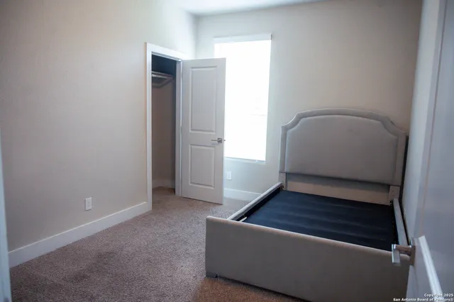 an empty room with wooden floor and window