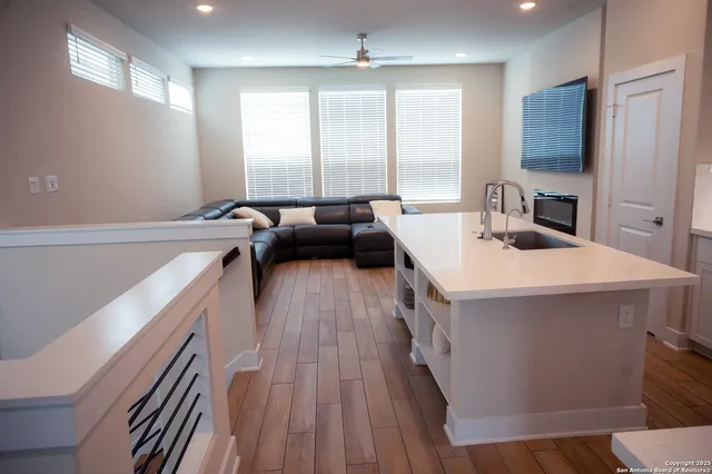 a kitchen with a sink appliances and cabinets