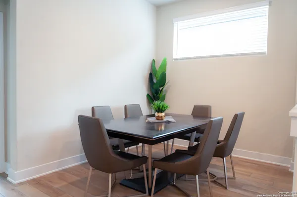 a view of a dining room with furniture and a potted plant