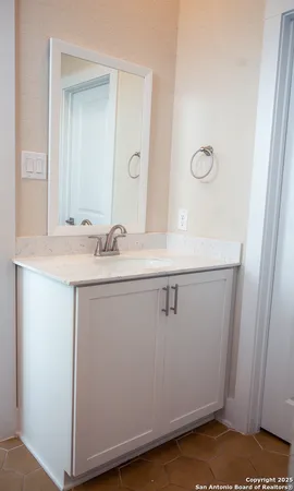 a bathroom with a sink and a mirror