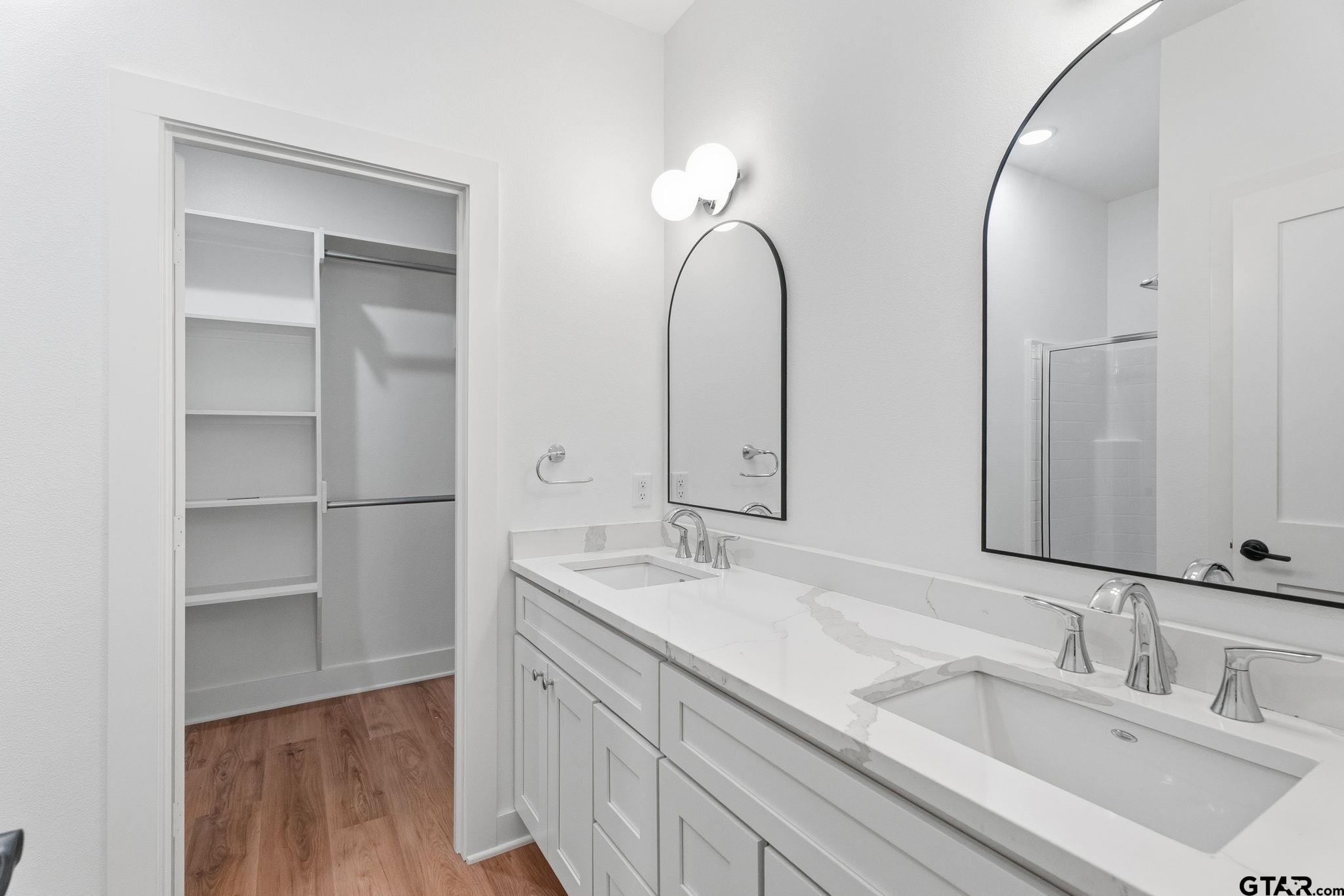 2968 Calloway Road Tyler, TX 75701 - Photo 11 of 24 a bathroom with a double vanity sink and a mirror