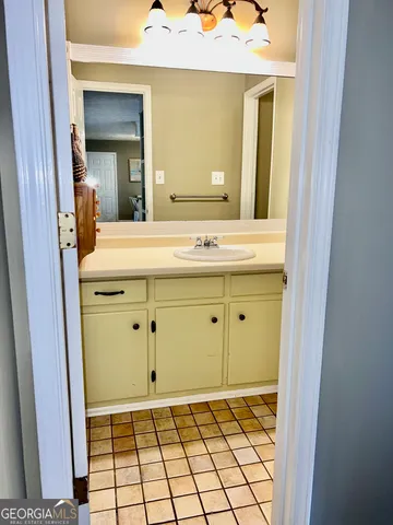 a bathroom with a sink a vanity and a mirror