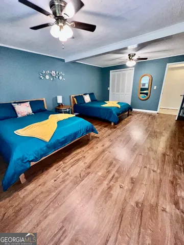 a bedroom with a bed and a large mirror