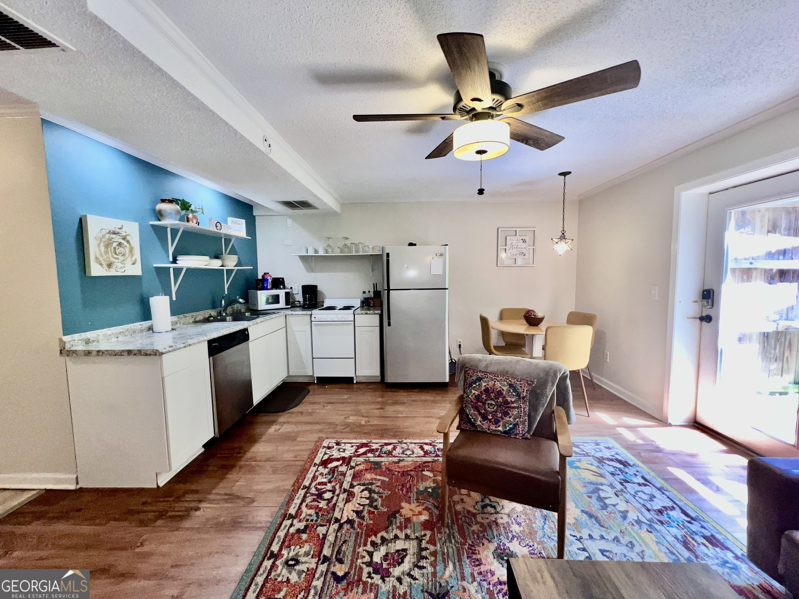 256 Cherokee Ridge Athens, GA 30606 - Photo 24 of 35 a living room with furniture kitchen view and a wooden floor