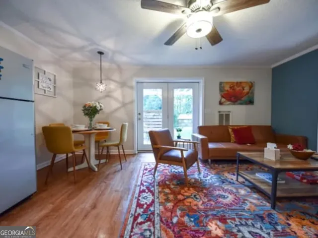 a living room with furniture and a chandelier