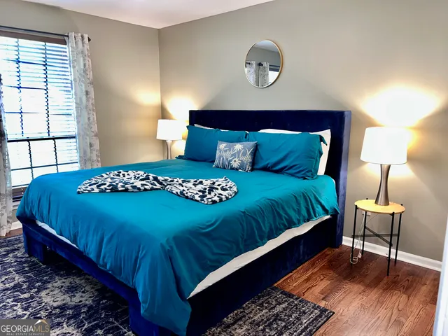 a bedroom with a bed and a lamp