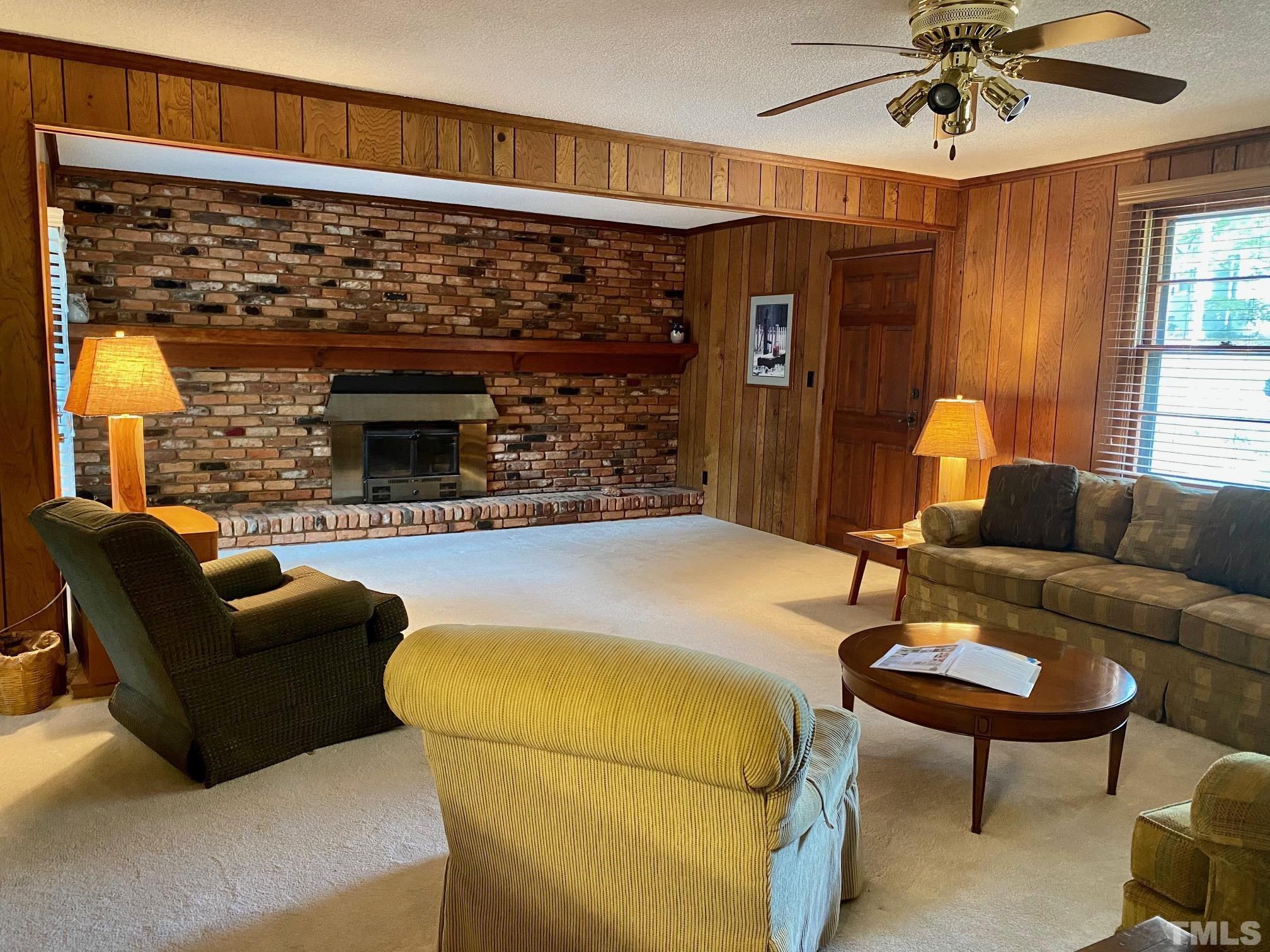 2101 Watkins Street Raleigh, NC 27604 - Photo 3 of 15 a living room with furniture and a fireplace