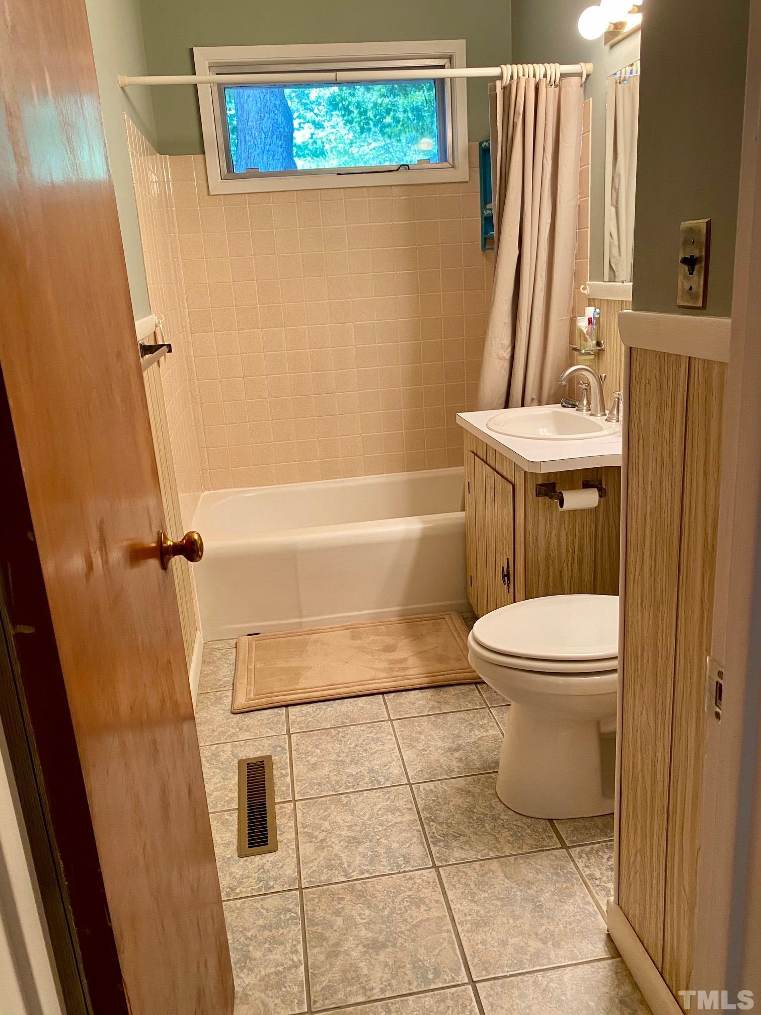 2101 Watkins Street Raleigh, NC 27604 - Photo 6 of 15 a bathroom with a toilet a sink and a shower