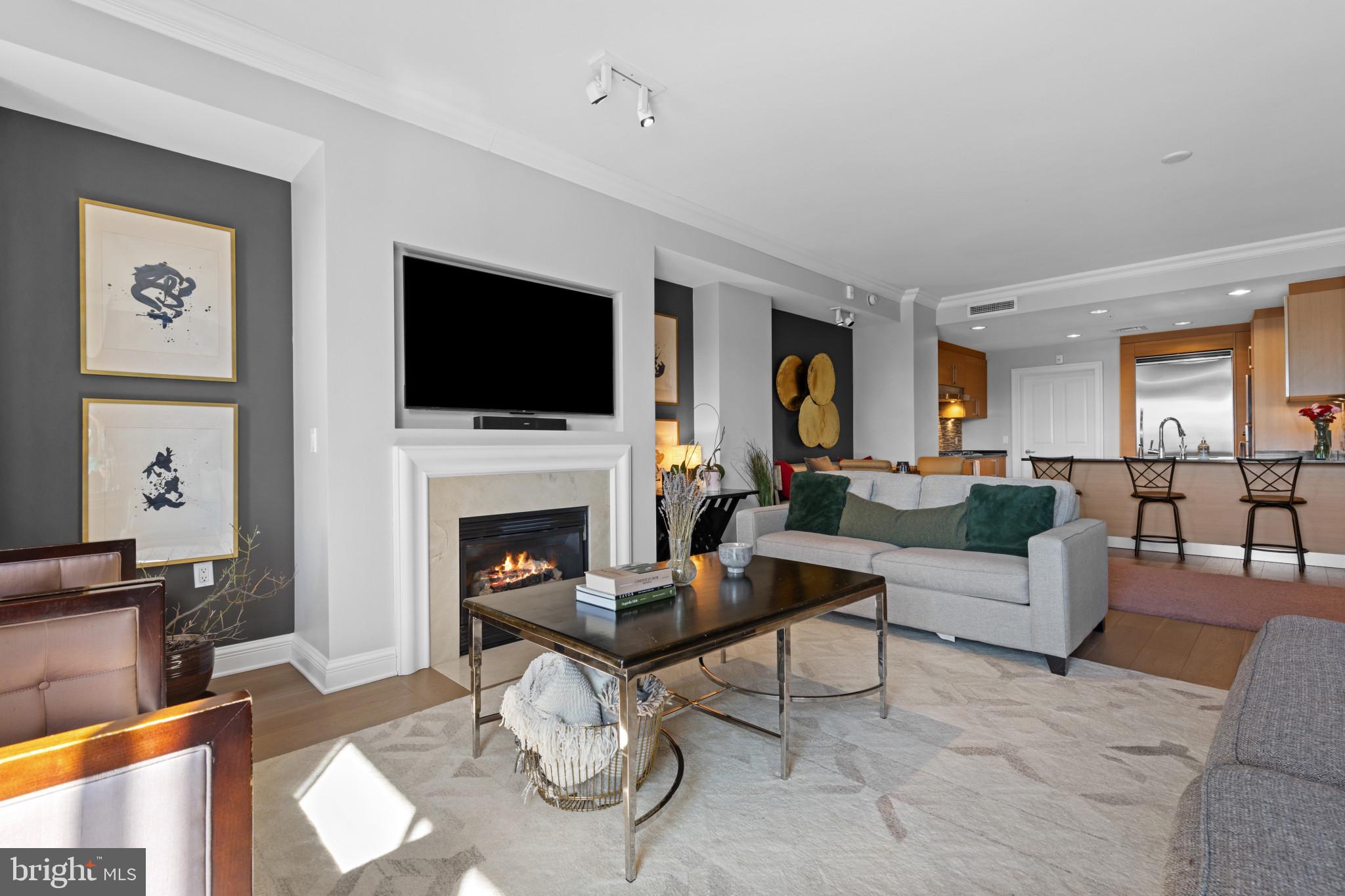 801 Key Highway, Unit T70 Baltimore, MD 21230 - Photo 13 of 43 a living room with furniture a fireplace and a flat screen tv