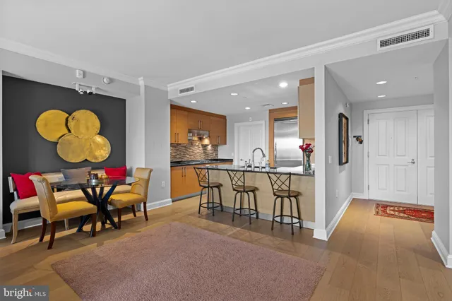 a living room with furniture and a kitchen