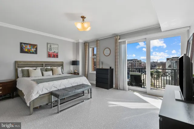 a spacious bedroom with a bed and a chandelier