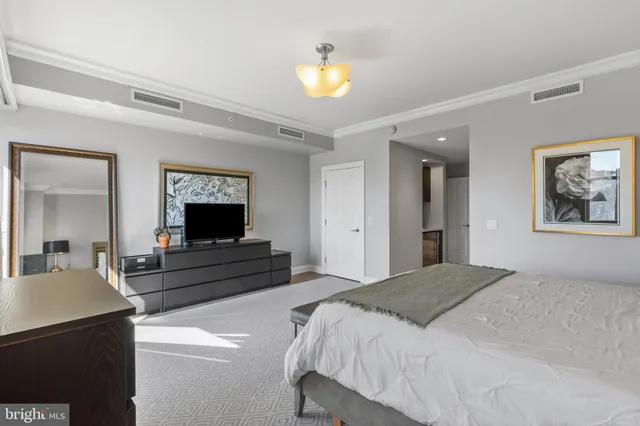 a bedroom with a bed and a chandelier