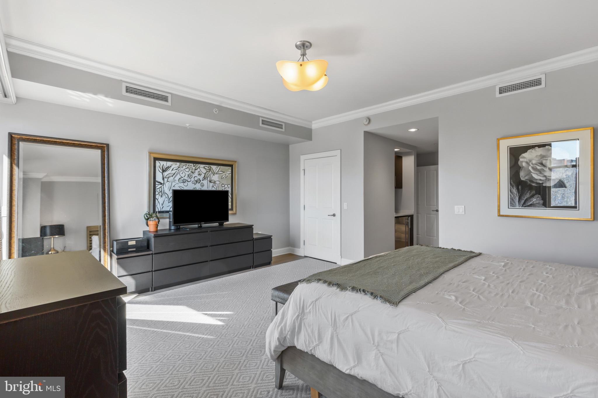 801 Key Highway, Unit T70 Baltimore, MD 21230 - Photo 30 of 43 a bedroom with a bed and a chandelier