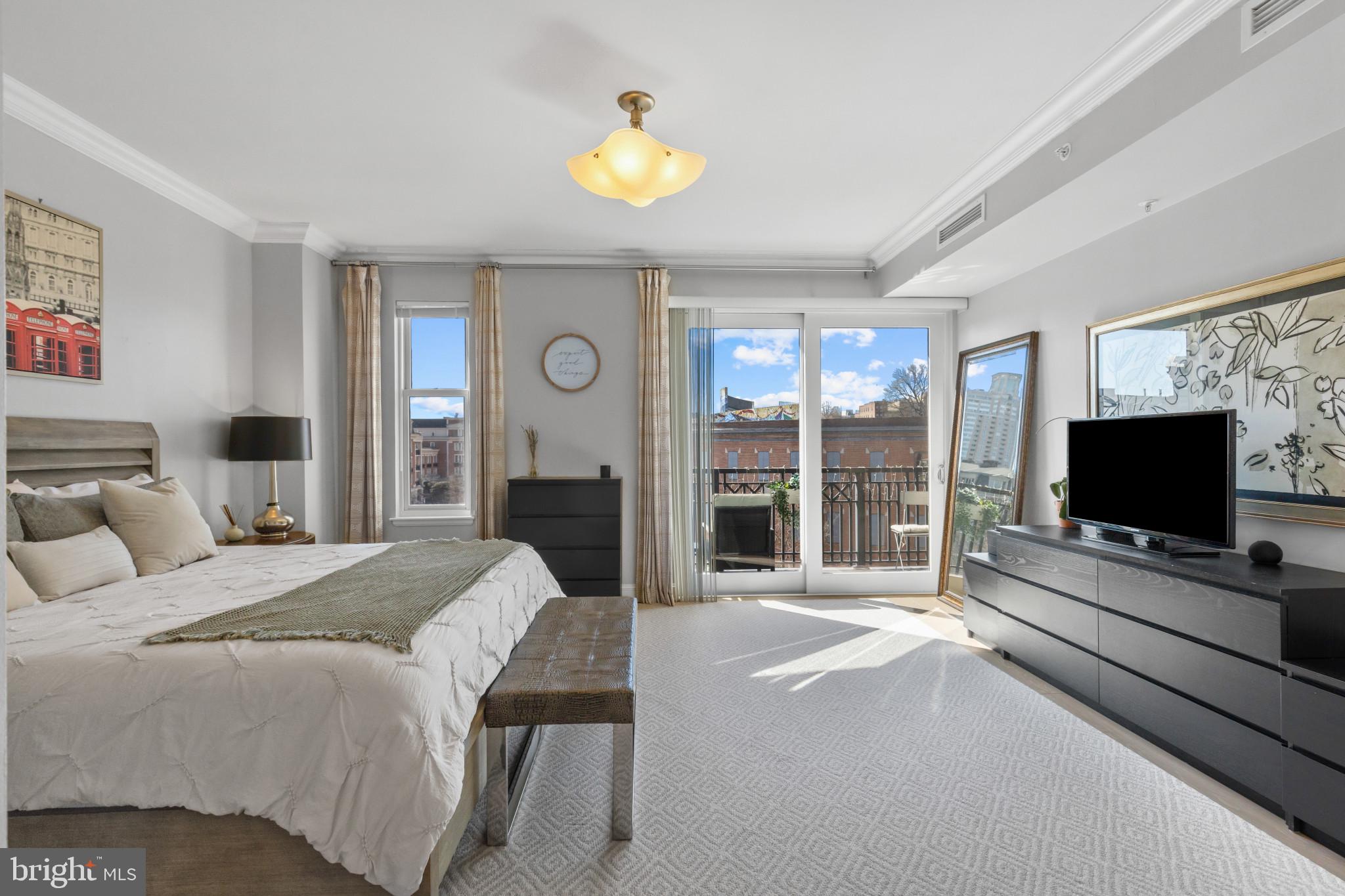 801 Key Highway, Unit T70 Baltimore, MD 21230 - Photo 31 of 43 a spacious bedroom with a bed and a flat screen tv