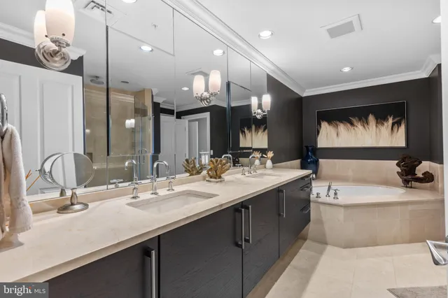 a large hall with kitchen island granite countertop a large tub and couches